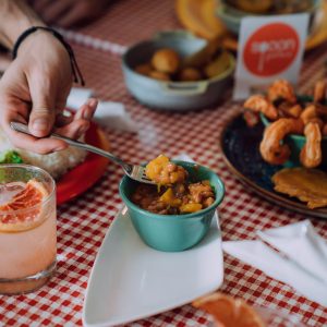 a person sitting at a table with a plate of food