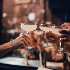 a hand holding a glass of wine