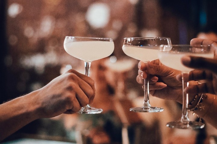 a hand holding a glass of wine