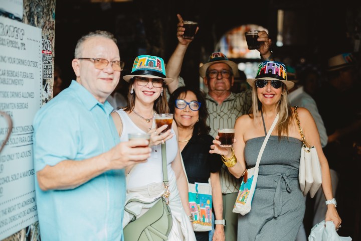 a person holding a pair of people posing for the camera